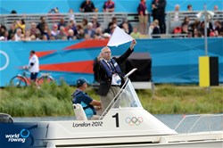 An umpire shows a white flag at the end of each final at the 2012 Olympic Rowing Regatta at Eton-Dorney near London, Great Britain.