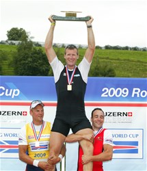 Podium of the Men's Single Sculls at the 2009 Rowing World Cup in Lucerne, Switzerland: Olaf Tufte from Norway (l, silver) and Tim Maeyens from Belgium (bronze) and holding the winner Mahe Drysdale from New Zealand.